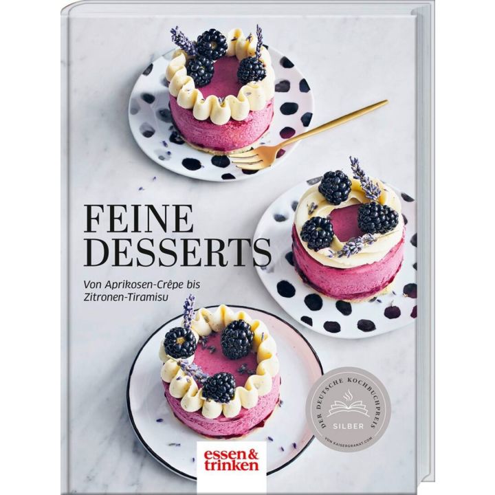 Buchcover: "Feine Desserts". Drei Himbeert&ouml;rtchen mit Brombeeren und Sahne auf gepunkteten Tellern, verziert mit Lavendel. Text: "Von Aprikosen-Cr&ecirc;pe bis Zitronen-Tiramisu". Logo: essen & trinken.